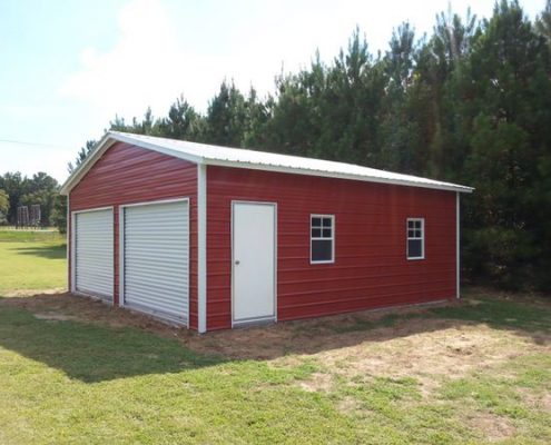 red metal building with two garage doors and side door and windows