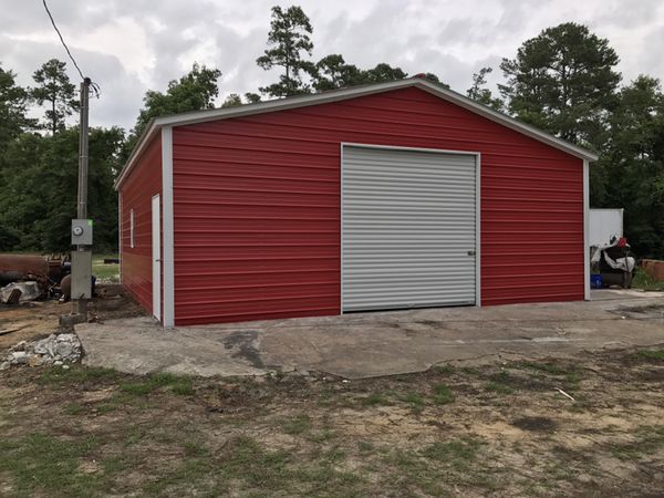 red metal building with garage door