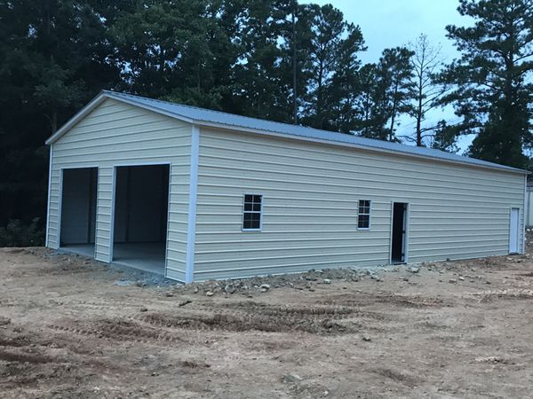 off white metal building with doors and windows